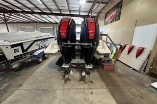 Slide: The Image of 2021 Velocity 290 Sport Cruiser with dual outboard motors in a storage facility. - 10