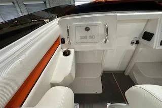 Slide: The Image of 2021 Velocity 290 Sport Cruiser interior with white seating and storage compartment. - 19