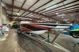 Slide: The Image of 2021 Velocity 290 Sport Cruiser in warehouse, vibrant red and black design. - 2