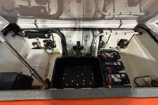 Slide: The Image of Engine compartment of 2021 Velocity 290 Sport Cruiser with visible batteries and wiring. - 22