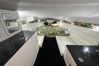 Slide: The Image of Interior of 2021 Velocity 290 Sport Cruiser with floral bedding and white seating. - 23
