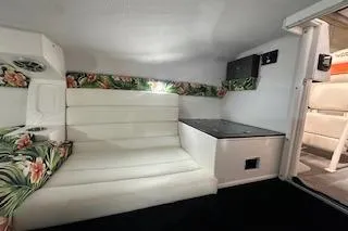 Slide: The Image of 2021 Velocity 290 Sport Cruiser interior with white seating and floral accents. - 27