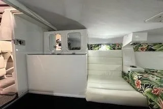 Slide: The Image of Interior of 2021 Velocity 290 Sport Cruiser with floral upholstery and white seating. - 28
