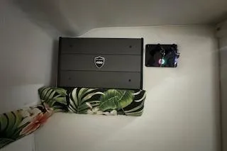 Slide: The Image of Amplifier installed in 2021 Velocity 290 Sport Cruiser with tropical-patterned cushion. - 29