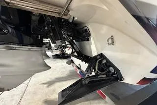 Slide: The Image of 2021 Velocity 290 Sport Cruiser boat engine and propeller detail in a garage setting. - 31