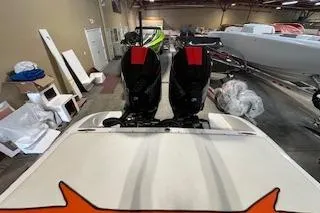 Slide: The Image of 2021 Velocity 290 Sport Cruiser with dual outboard motors in a showroom. - 32