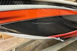 Slide: The Image of 2021 Velocity 290 Sport Cruiser with sleek red and black carbon fiber design. - 36