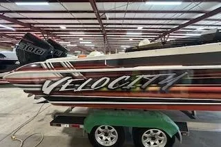 Slide: The Image of 2021 Velocity 290 Sport Cruiser boat on trailer in warehouse setting. - 4
