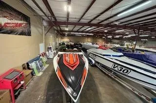 Slide: The Image of 2021 Velocity 290 Sport Cruiser in a showroom with other boats. - 5
