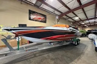 Slide: The Image of 2021 Velocity 290 Sport Cruiser in a showroom, vibrant orange and black design. - 6