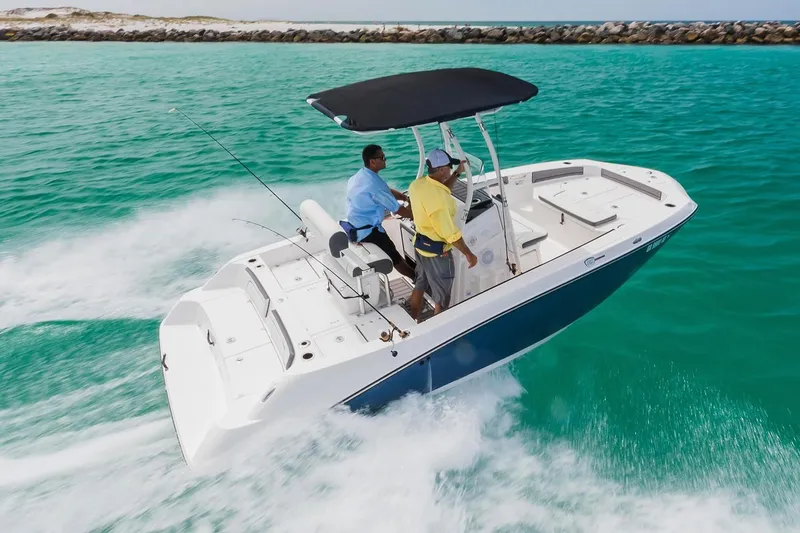 Slide: The Image of 2018 Yamaha 190 FSH Sport boat on turquoise water. - 4