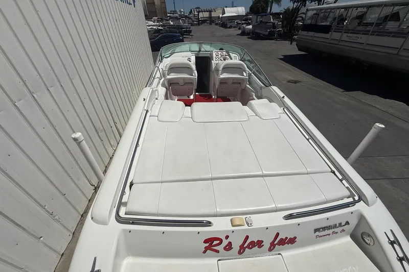 Slide: The Image of 2001 Formula 353 FASTech boat with white seating and "R's for fun" text on the back. - 10