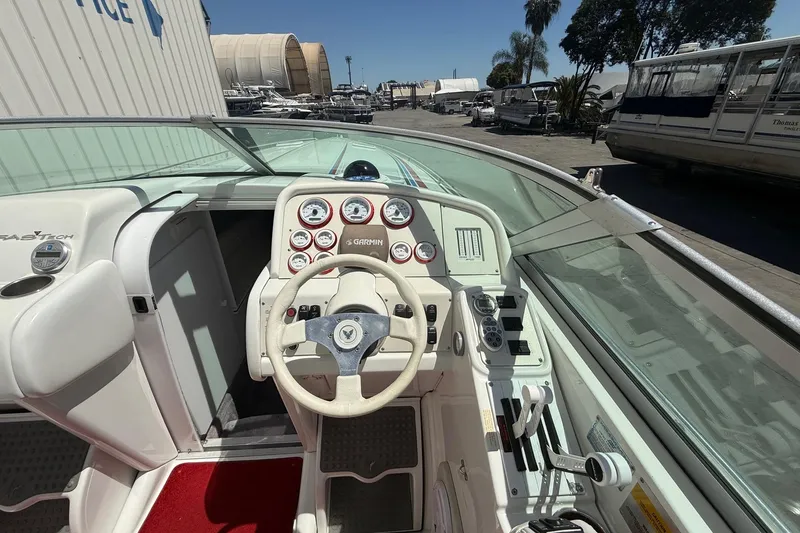 Slide: The Image of Cockpit of a 2001 Formula 353 FASTech boat with steering wheel and gauges. - 12