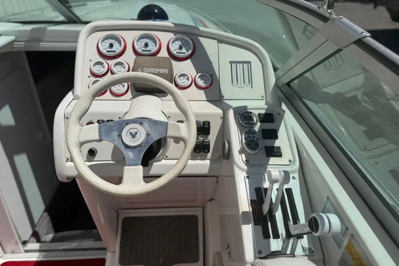 Slide: The Image of Cockpit of 2001 Formula 353 FASTech boat with steering wheel and control panel. - 13
