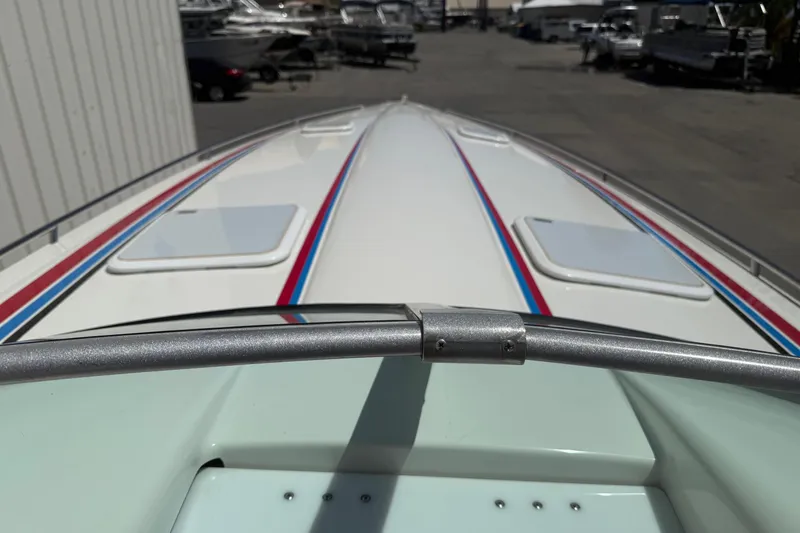 Slide: The Image of 2001 Formula 353 FASTech boat deck with red and blue stripes in a marina. - 16