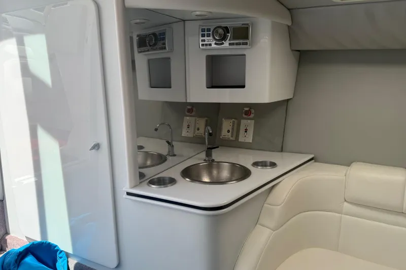 Slide: The Image of Interior of a 2001 Formula 353 FASTech boat featuring a compact kitchenette with sink and seating. - 28
