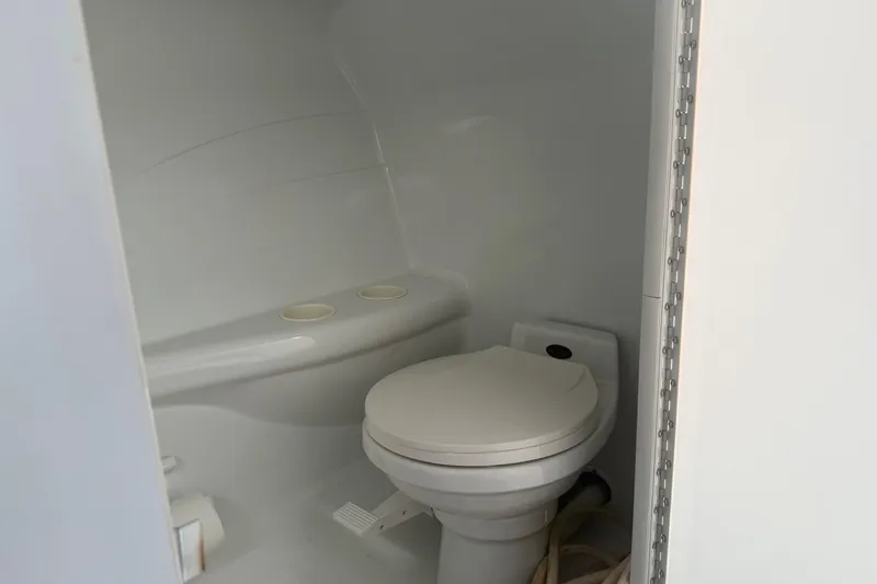 Slide: The Image of Compact marine toilet in a 2001 Formula 353 FASTech boat cabin. - 31