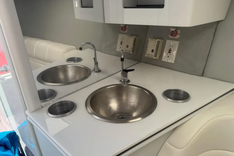 Slide: The Image of Interior of 2001 Formula 353 FASTech boat featuring a sleek kitchenette with sink and outlets. - 32