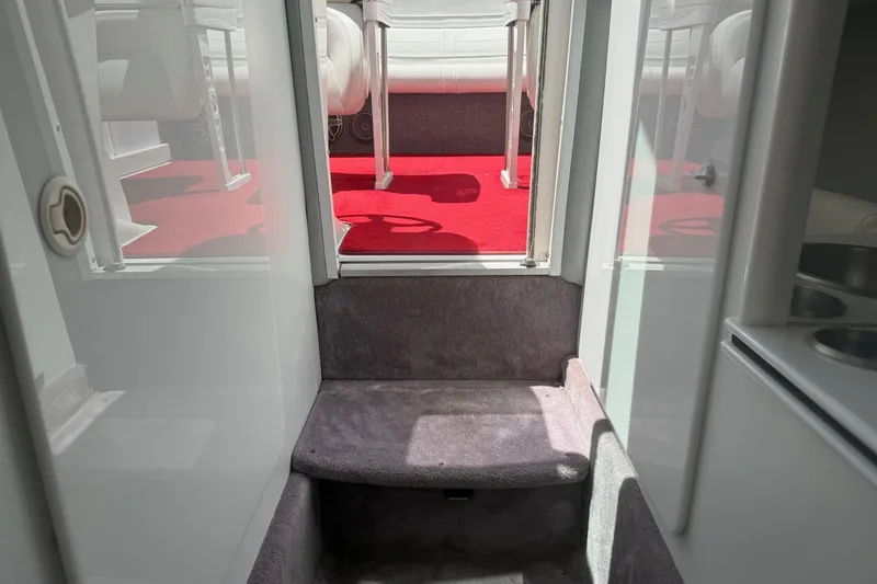 Slide: The Image of Interior view of a 2001 Formula 353 FASTech boat with red carpet and seating area. - 33
