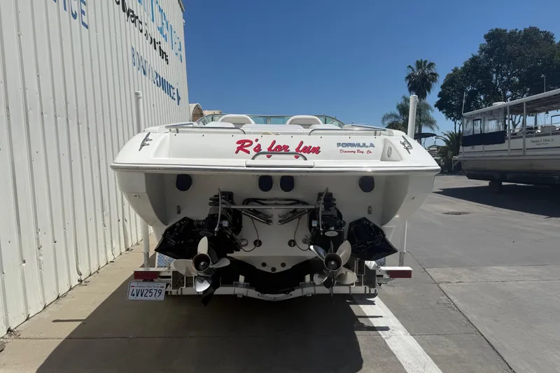 Slide: The Image of 2001 Formula 353 FASTech boat rear view, parked outdoors, showcasing dual propellers. - 5
