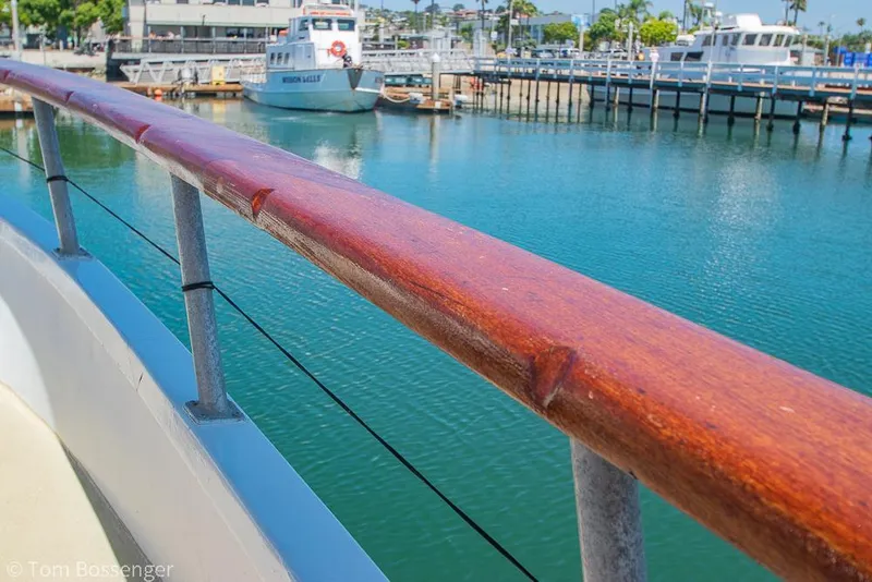 Slide: The Image of 1975 Blanchard Passenger Sportfisher boat railing with marina view in background. - 14