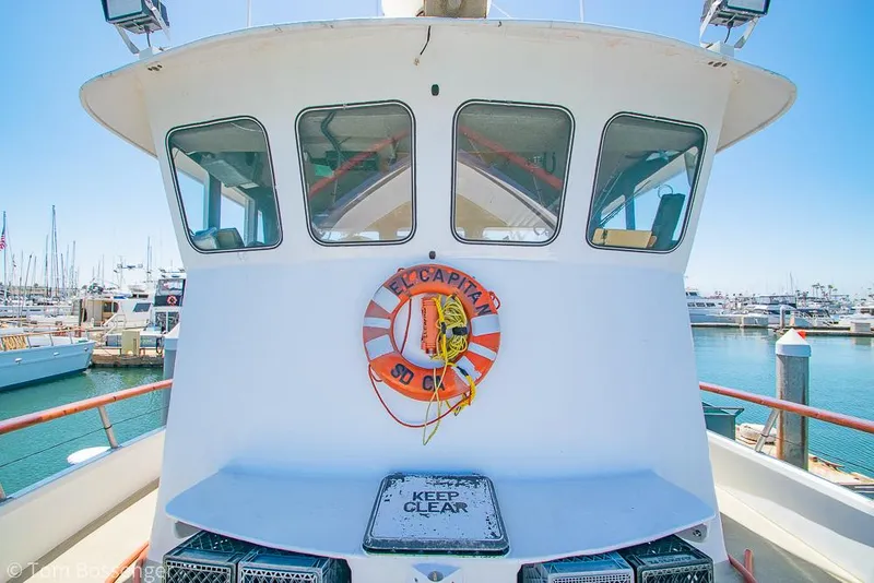 Slide: The Image of 1975 Blanchard Passenger Sportfisher boat docked at marina, featuring lifebuoy and "Keep Clear" sign. - 16