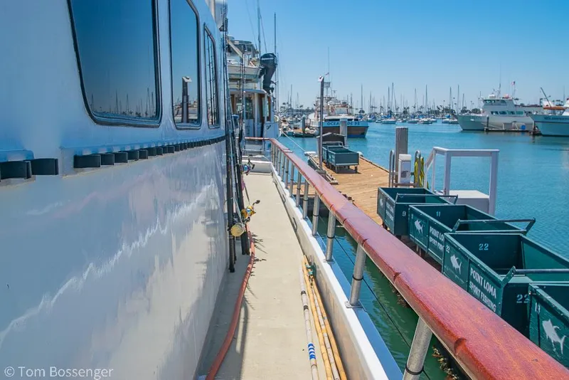 Slide: The Image of 1975 Blanchard Passenger Sportfisher docked at marina, surrounded by boats and clear blue sky. - 19