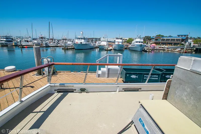Slide: The Image of 1975 Blanchard Passenger Sportfisher docked at a marina with clear blue skies. - 21