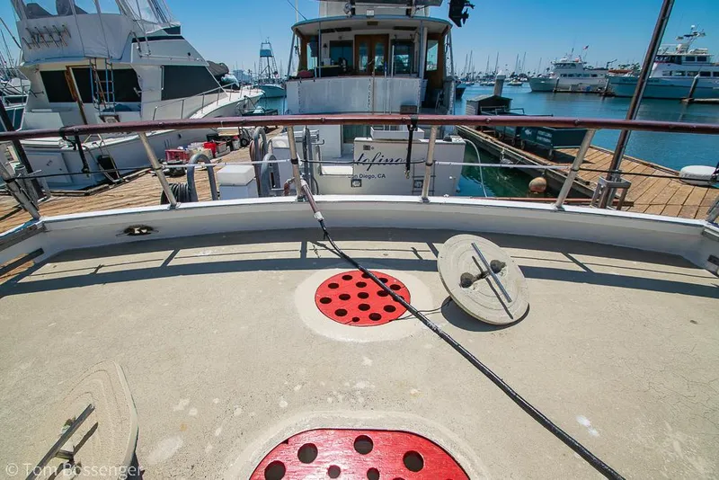Slide: The Image of 1975 Blanchard Passenger Sportfisher docked at marina, showcasing deck and nautical equipment. - 23