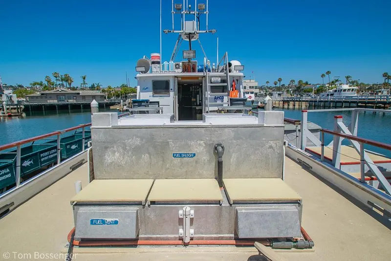 Slide: The Image of 1975 Blanchard Passenger Sportfisher docked at a marina under clear blue skies. - 24
