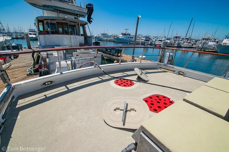 Slide: The Image of 1975 Blanchard Passenger Sportfisher boat docked in a marina, sunny day, clear blue sky. - 26