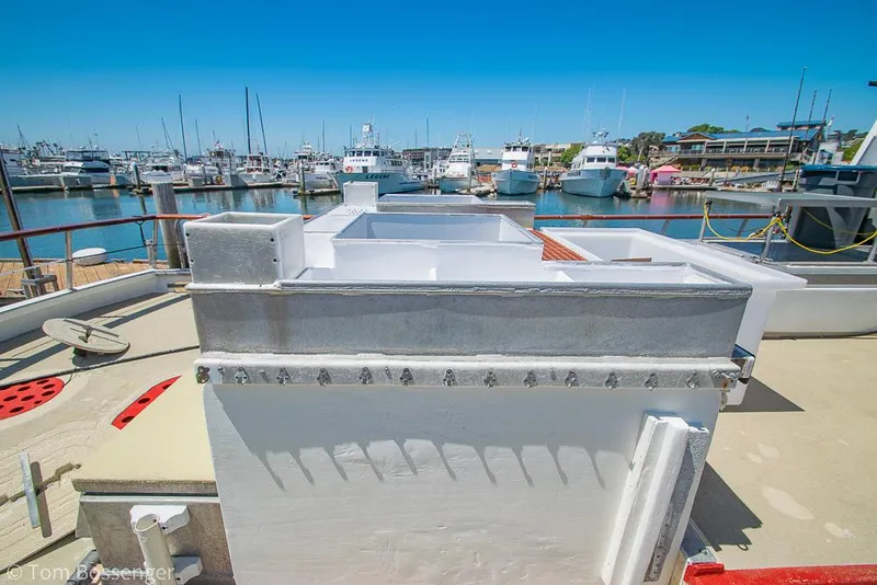 Slide: The Image of 1975 Blanchard Passenger Sportfisher boat docked in a marina under clear blue skies. - 28