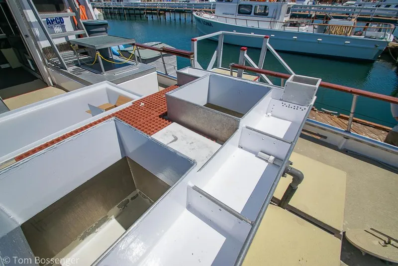 Slide: The Image of 1975 Blanchard Passenger Sportfisher deck with storage compartments, docked at marina. - 32