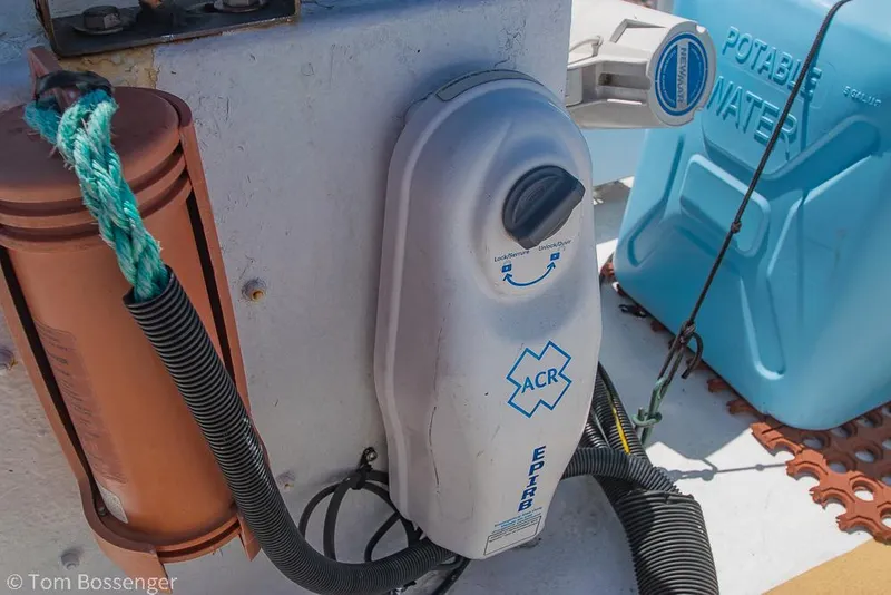 Slide: The Image of 1975 Blanchard Passenger Sportfisher boat equipment, featuring ACR device and potable water container. - 38