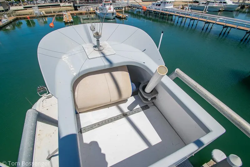 Slide: The Image of 1975 Blanchard Passenger Sportfisher boat detail at marina, showcasing upper deck and seating area. - 42