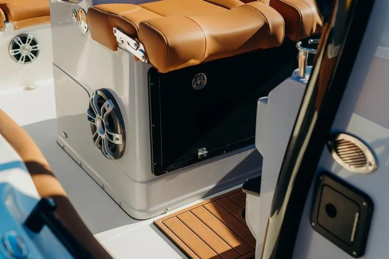Slide: The Image of Interior of 2026 Key West 239 FSR boat with brown seating and speaker system. - 11