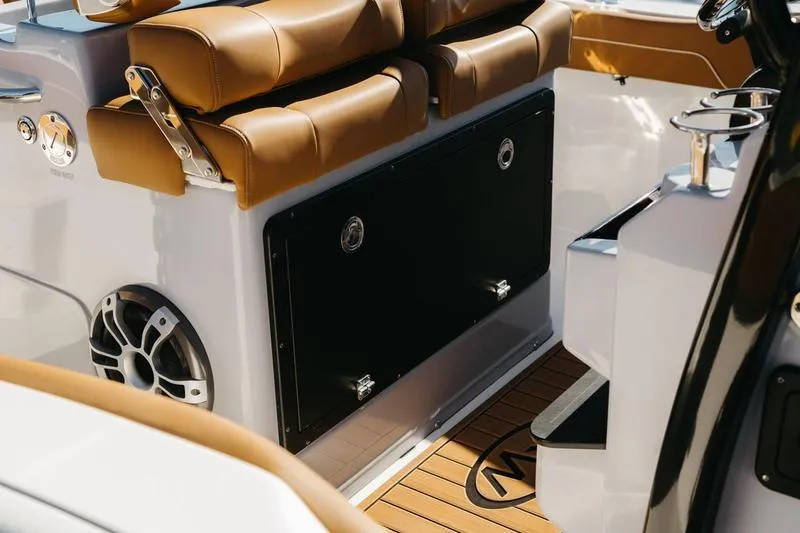 Slide: The Image of 2026 Key West 239 FSR boat interior with tan seating and wood flooring. - 24