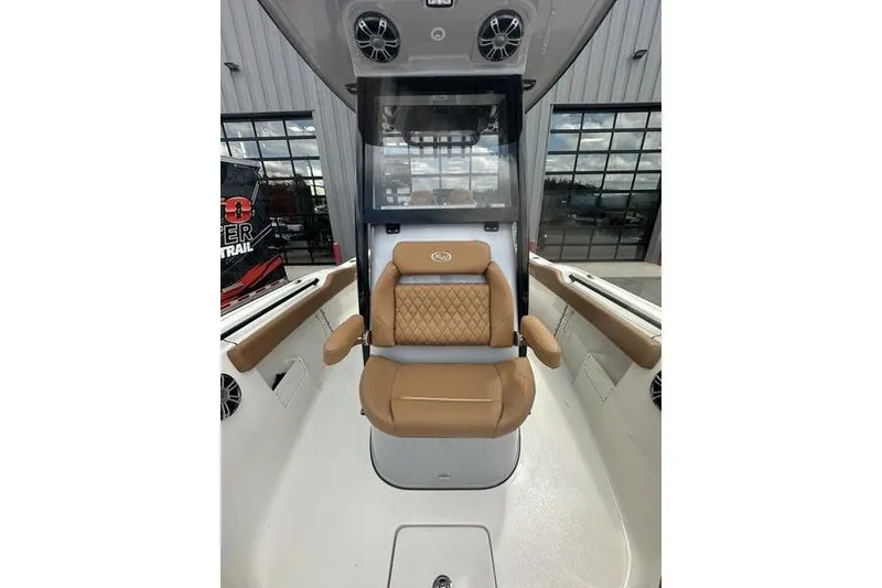 Slide: The Image of 2026 Key West 239 FSR boat interior with tan seating and modern console. - 29