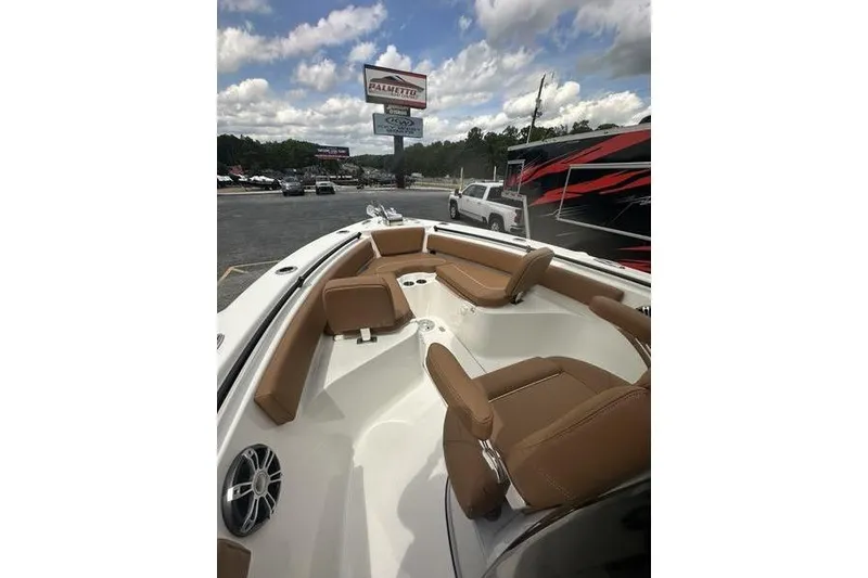Slide: The Image of 2026 Key West 239 FSR boat with brown seating, parked outdoors under a cloudy sky. - 31