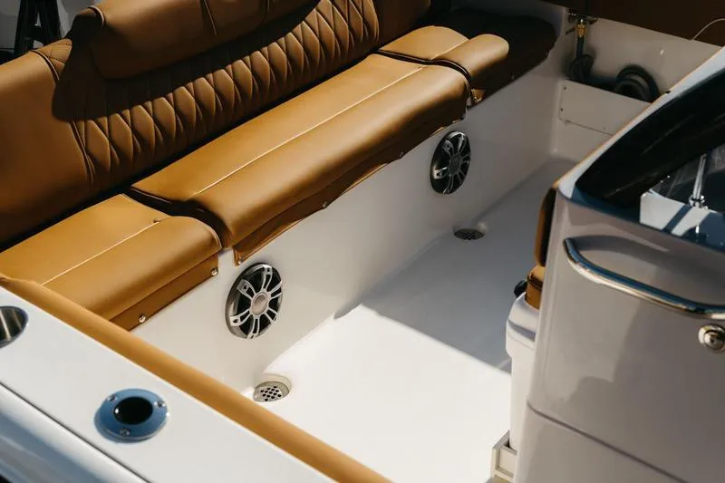 Slide: The Image of Luxurious seating on 2026 Key West 239 FSR boat with tan upholstery and built-in speakers. - 32