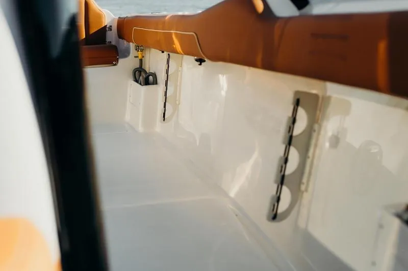 Slide: The Image of Interior view of 2026 Key West 239 FSR boat with tan seating and white deck. - 33