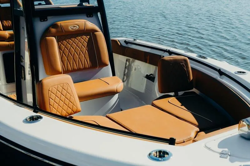 Slide: The Image of Luxurious seating on 2026 Key West 239 FSR boat, featuring tan leather upholstery by the water. - 42