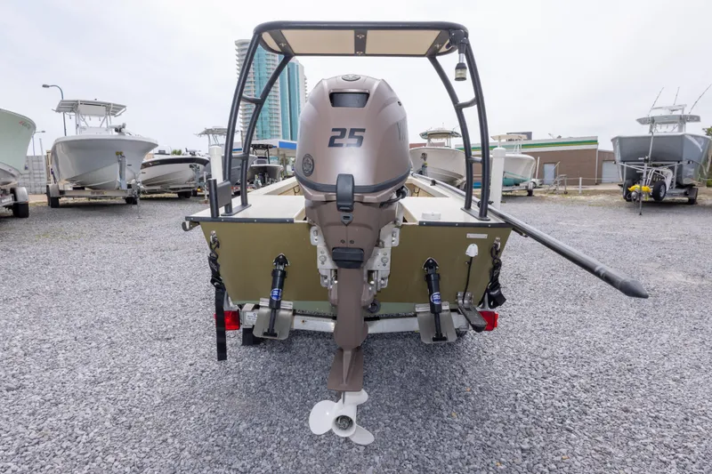 Slide: The Image of Rear view of a 2016 Salt Marsh 1444 boat with an outboard motor, parked on gravel. - 10