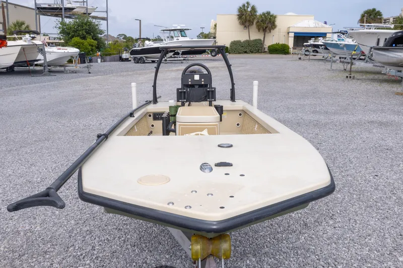 Slide: The Image of 2016 Salt Marsh 1444 boat on gravel lot, surrounded by other boats and greenery. - 11