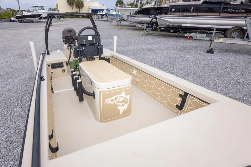 Slide: The Image of Salt Marsh 1444 boat interior with seating and storage, parked on gravel lot, 2016 model. - 12