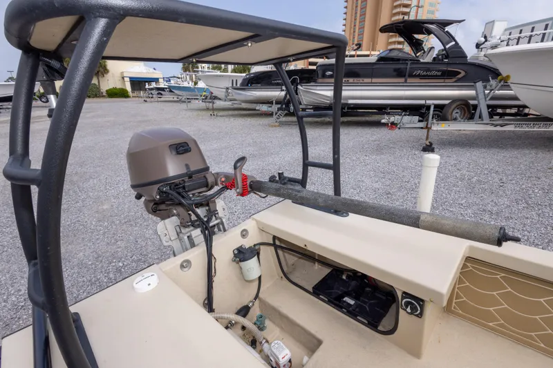Slide: The Image of Salt Marsh 1444 boat with motor, parked on gravel lot, surrounded by other boats. - 15