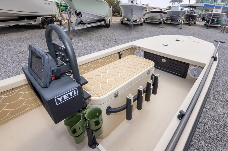 Slide: The Image of 2016 Salt Marsh 1444 boat interior with Yeti cooler and fishing rod holders. - 17