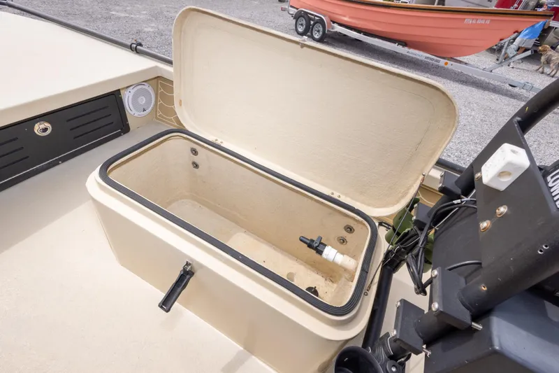 Slide: The Image of Open storage compartment on a 2016 Salt Marsh 1444 boat, with visible speaker and controls. - 19