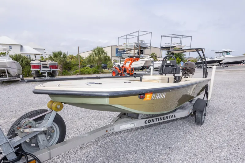 Slide: The Image of 2016 Salt Marsh 1444 boat on trailer in marina with other boats. - 2