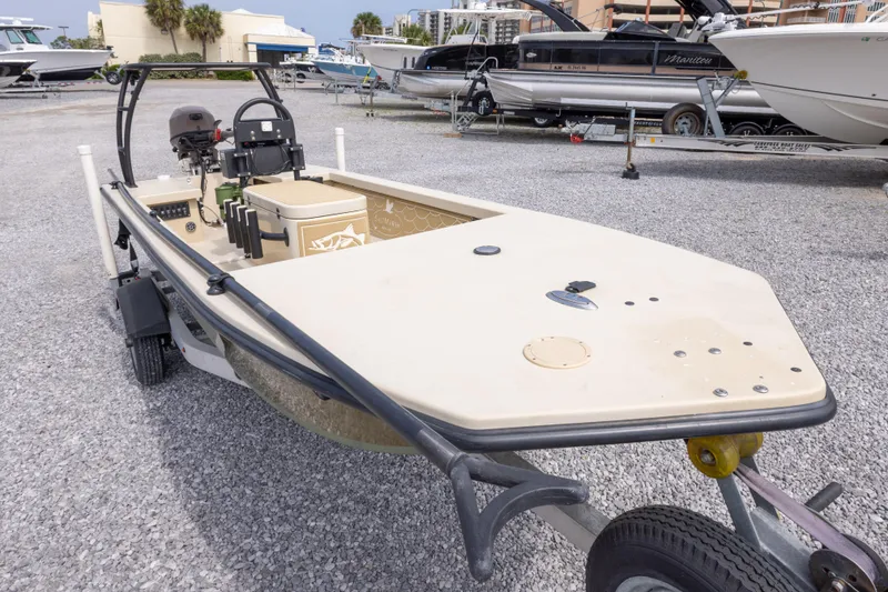Slide: The Image of 2016 Salt Marsh 1444 boat on trailer in marina, surrounded by other boats. - 3